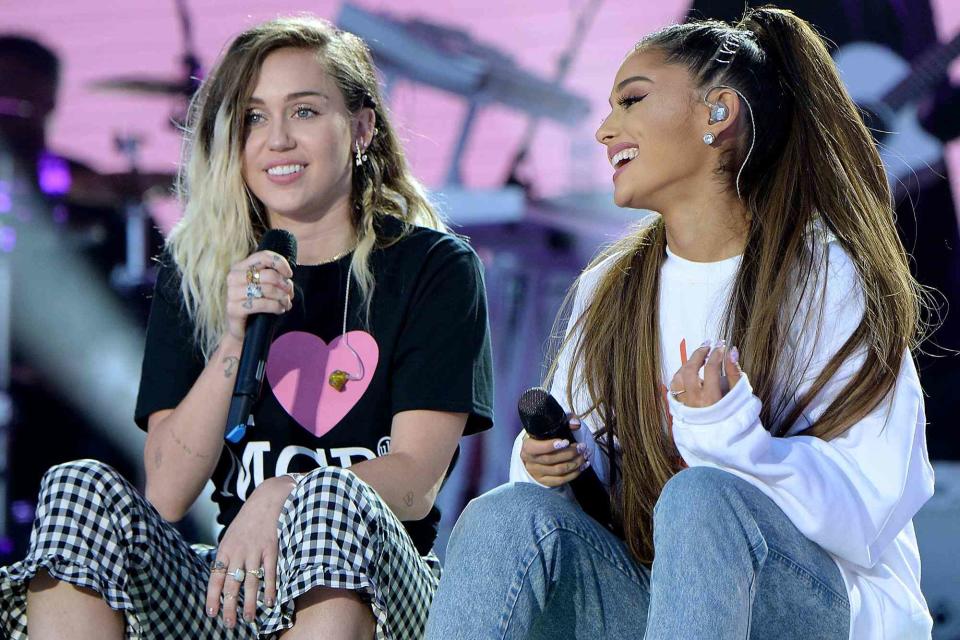 <p>Kevin Mazur/One Love Manchester/Getty</p> Miley Cyrus and Ariana Grande in June 2017