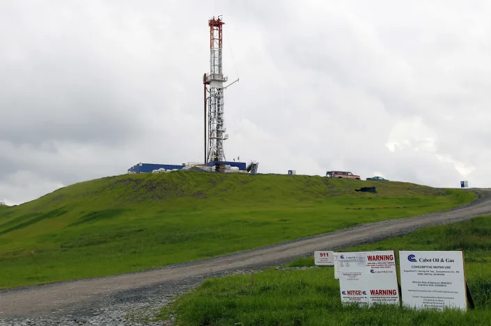 FILE - In this file photo from Oct. 14, 2011, a drilling rig is seen in Springville, Pa. State regulators blamed faulty gas wells drilled for leaking methane into the groundwater in nearby Dimock, Pa. One of the best-known pollution cases ever to emerge from the U.S. drilling and fracking boom has entered a difficult new phase as prosecutors pursue criminal charges against Pennsylvania’s busiest gas driller. The attorney general’s office is pushing for a settlement they say could yield more significant benefits for affected homeowners than a conviction. (AP Photo/Alex Brandon, File)