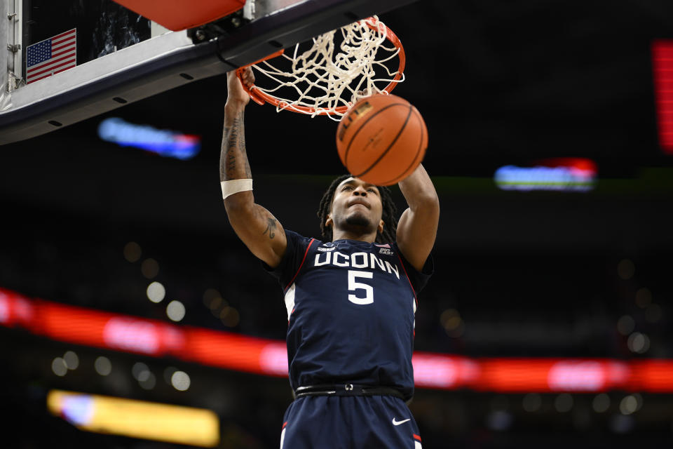 Connecticut guard Stephon Castle (5) dunks during the first half of an NCAA college basketball game against Georgetown, Saturday, Feb. 10, 2024, in Washington. (AP Photo/Nick Wass)