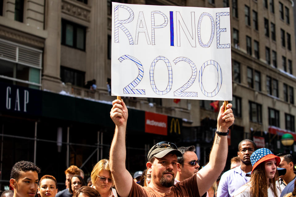 A fan holds a "Rapinoe 2020" sign as the U.S. women's soccer team makes its way up Broadway's Canyon of Heroes. (Photo: Demetrius Freeman for HuffPost)