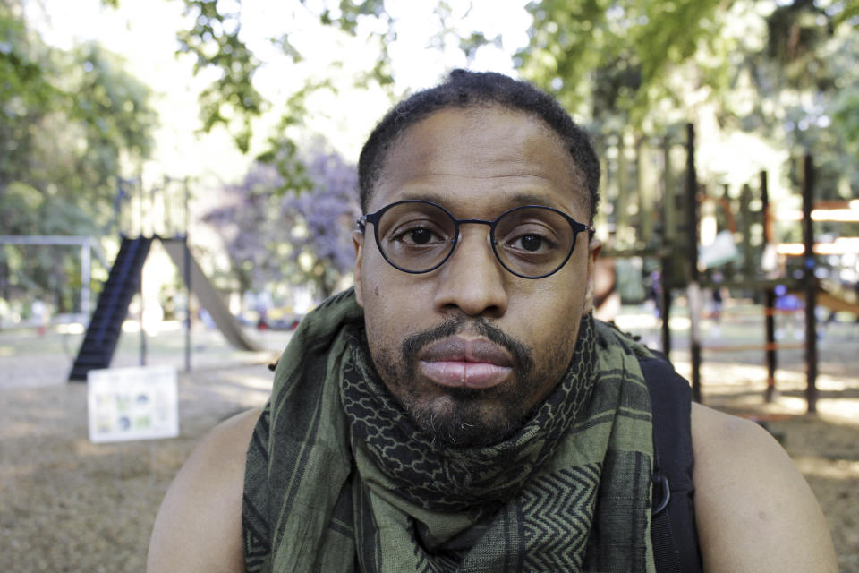 Mac Smiff poses for a photograph in Wilshire Park in Portland, Ore., on Wednesday, July 29, 2020. Smiff, who has been protesting almost every night for weeks, was arrested by the Portland Police Bureau while attending a Black Lives Matter protest. An Associated Press analysis of more than 200 arrests shows that even those accused of breaking the law during the nightly rallies don’t neatly fit into President Donald Trump’s depiction of protesters as “anarchists and agitators.” (AP Photo/Gillian Flaccus)