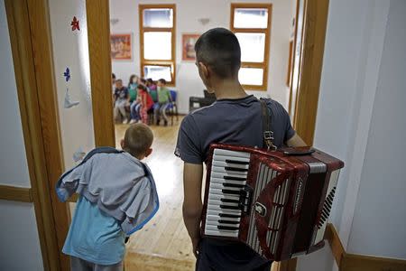 Members of children's choir "Superar" listen to other members practicing songs that will be performed during the Pope's visit to Sarajevo at their music school in Srebrenica, Bosnia and Herzegovina May 23, 2015. REUTERS/Dado Ruvic