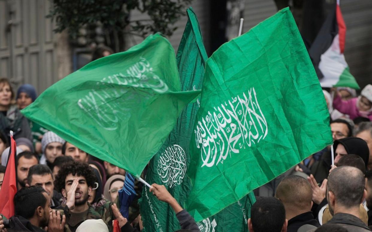 Palestinian demonstrators wave a Hamas flag during a protest in Ramallah in January 2024