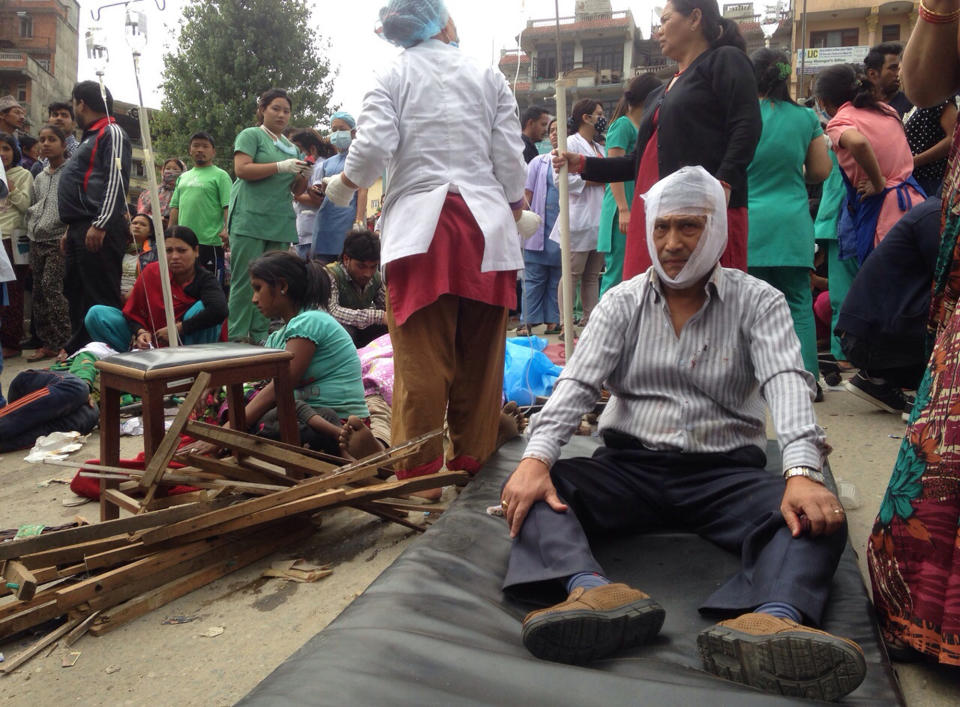 Injured people receive treatment outside the Medicare Hospital in Kathmandu. (AP Photo/ Niranjan Shrestha)