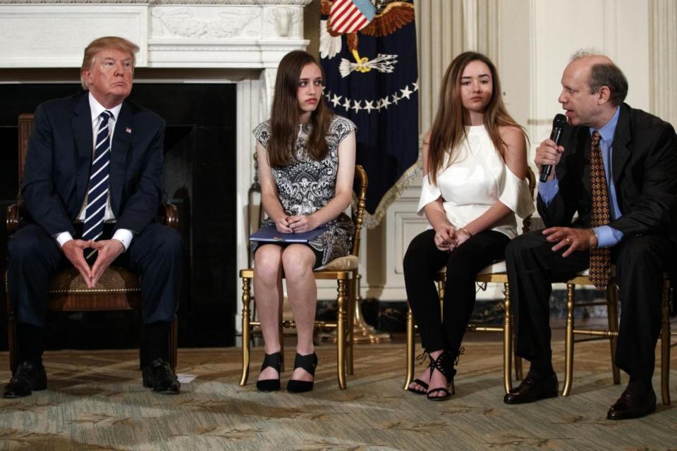 Listening session: Marjory Stoneman Douglas High School students Carson Abt and Ariana Klein listen as Carson's father Frederick speaks to Trump (AP)