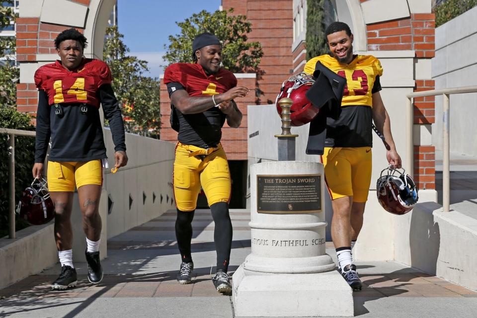 USC running back Raleek Brown, wide receiver Mario Williams and quarterback Caleb Williams walk together.