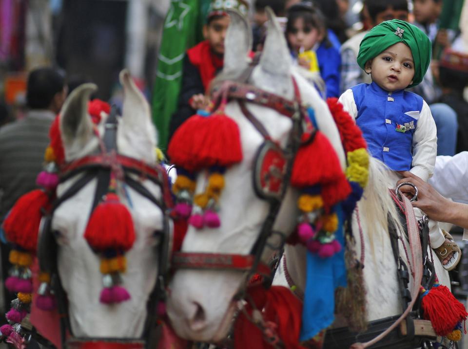 A Muslim boy poses as he sits on a horse during a religious procession to mark Eid-e-Milad-ul-Nabi, or birthday celebrations of Prophet Mohammad, in Delhi