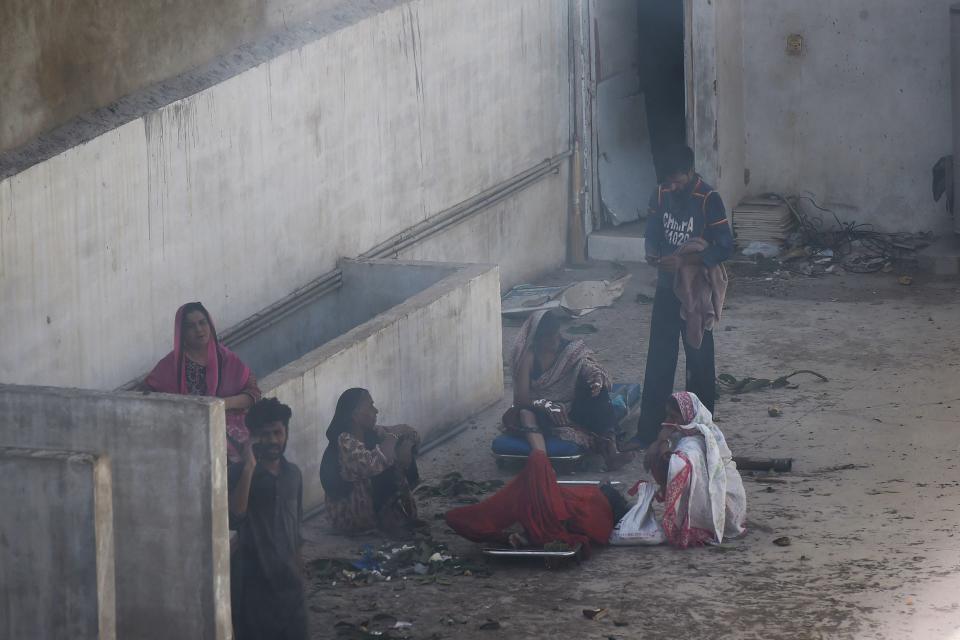 EDITORS NOTE: Graphic content / Residents help injured victims after a Pakistan International Airlines aircraft crashed in a residential neighbourhood in Karachi on May 22, 2020. - A Pakistan passenger plane with more than 100 people believed to be on board crashed in the southern city of Karachi on May 22, the country's aviation authority said. (Photo by Asif HASSAN / AFP) (Photo by ASIF HASSAN/AFP via Getty Images)