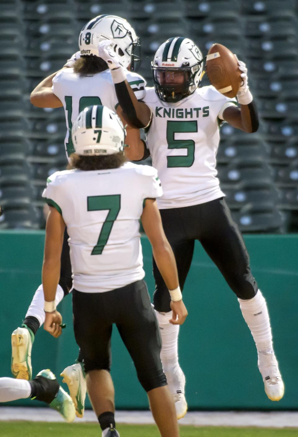Richwoods' Cory Wysinger (5) celebrates a touchdown with his teammates against Peoria Notre Dame in the first half Friday, Sept. 16, 2022 at Dozer Park.