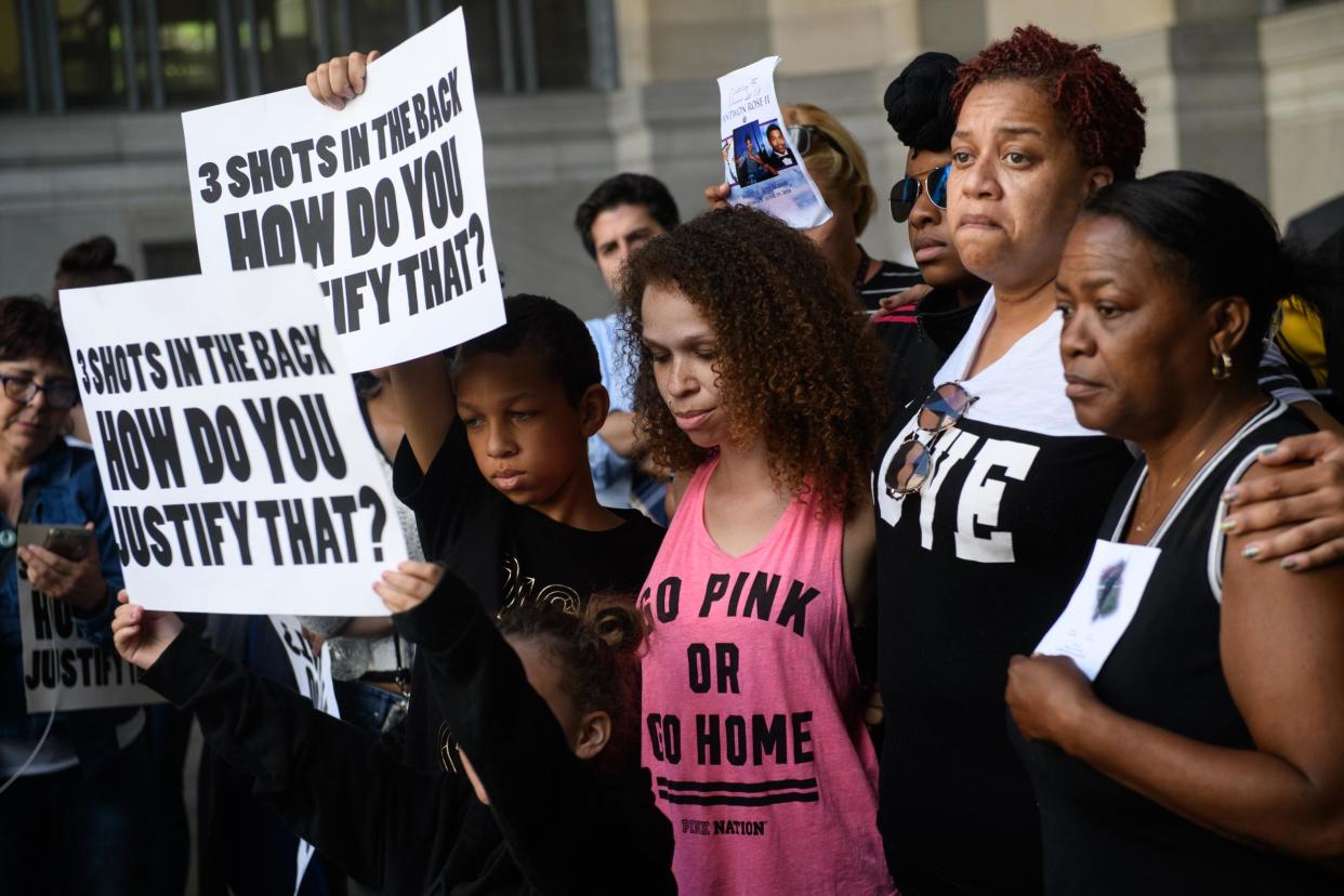 Family members of Antwon Rose II embrace as they listen to speakers during a protest calling for justice for the 17-year-old: Justin Merriman/Getty Images