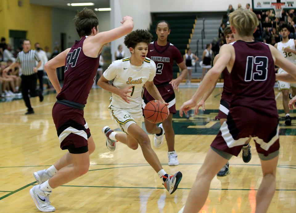 Salina South'sTe'Jon McDaniel (1) drives past Buhler's Jackson Voth (34) during their game Tuesday night, Dec. 7, 2021. Buhler defeated Salina South 57-47. McDaniel was the team's high scorer with 20 points in the game.