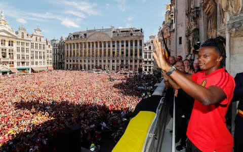 Belgium's Dedryck Boyata celebrates at the balcony in front of more than 8000 supporters at the Grand-Place, Grote Markt in Brussels city center, as Belgian national football team Red Devils arrive to celebrate with supporters at the balcony of the city hall after reaching the semi-finals and winning the bronze medal at the Russia 2018 World Cup, on July 15, 2018 - Credit: AFP