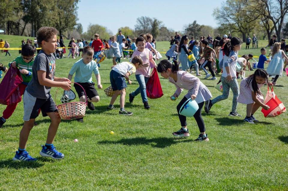 Children race to collect eggs during the Haggin Oaks Easter Egg Hunt on Sunday, April 9, 2023, in Sacramento.