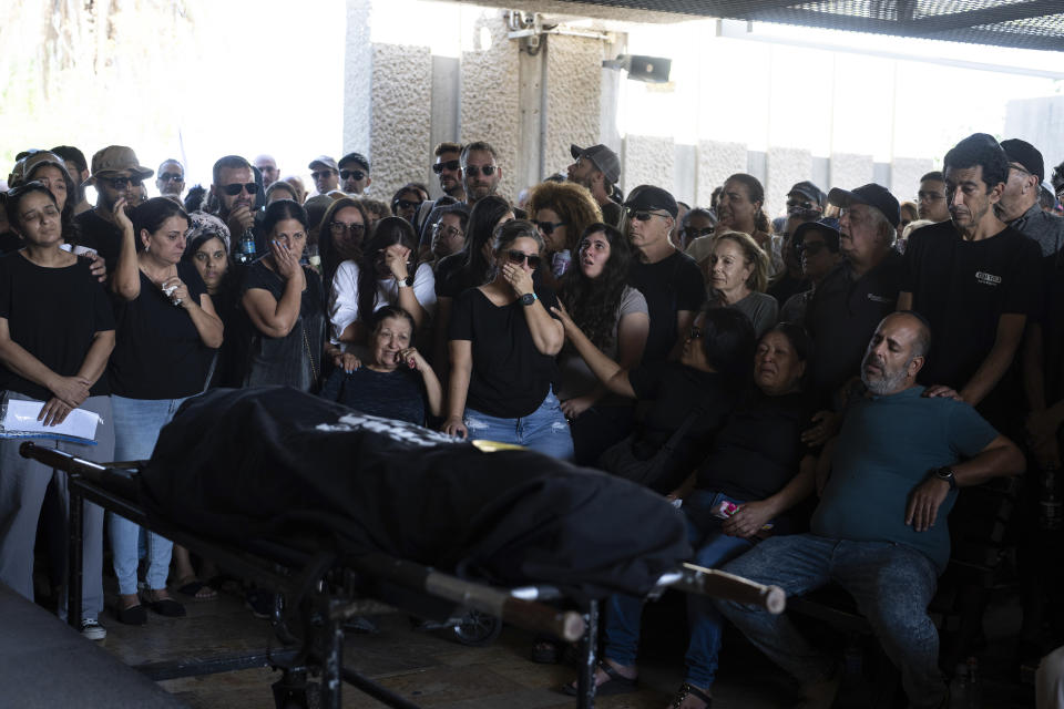 Mourners attend the funeral of the Israeli woman Shiraz Tamam, killed by Hamas militants while attending a music festival at a cemetery in Holon, central Israel, Tuesday, Oct. 17, 2023. (AP Photo/Petros Giannakouris