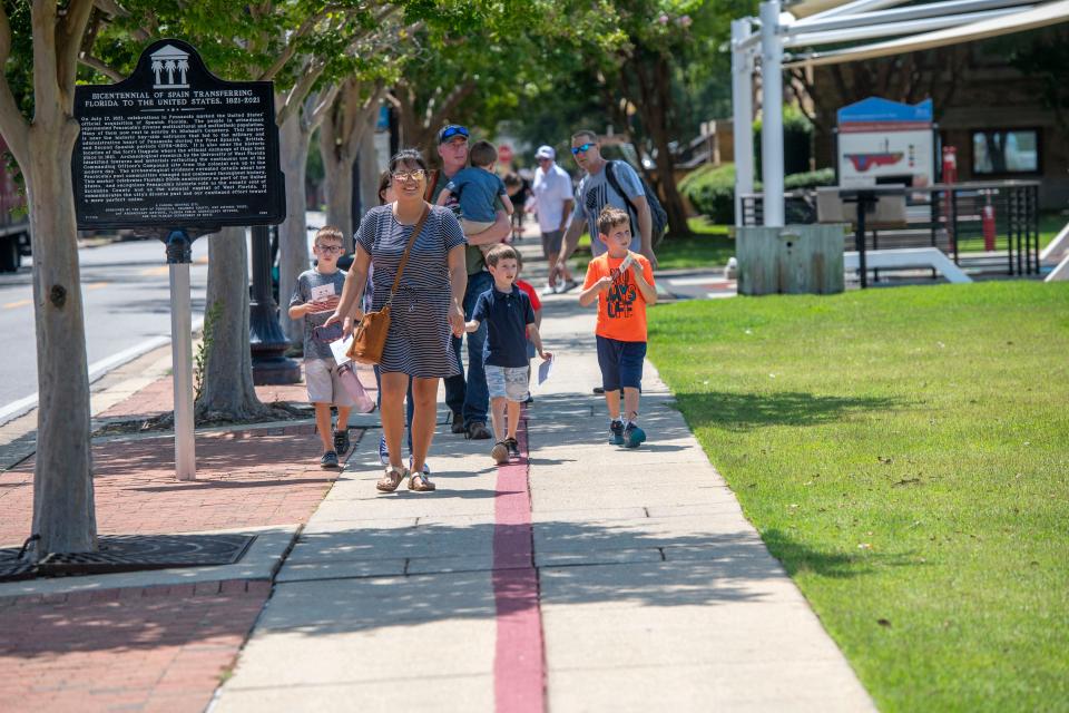 Attendees walk the America's First Settlement Trail in downtown Pensacola during last year's America's First Settlement Trail ribbon cutting at Plaza Ferdinand Vll.