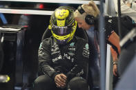 Mercedes driver Lewis Hamilton of Britain speaks to his personal assistant while waiting for the start of the second practice session for the Formula One Miami Grand Prix auto race at the Miami International Autodrome, Friday, May 6, 2022, in Miami Gardens, Fla. (AP Photo/Darron Cummings)