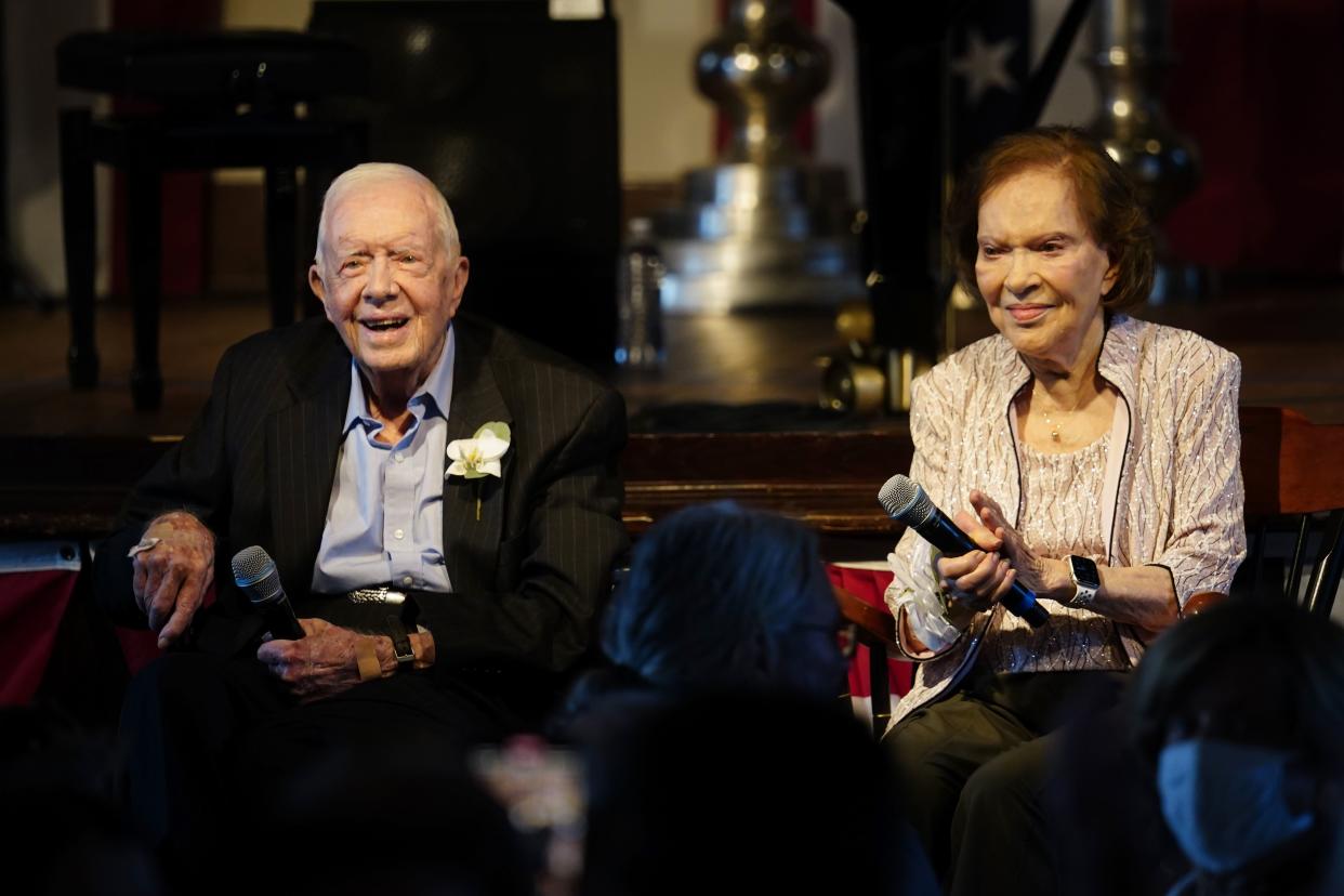 Former President Jimmy Carter and his wife former First Lady Rosalynn Carter sit together during a reception to celebrate their 75th anniversary Saturday in Plains, Ga..