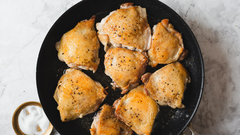 Seared chicken in pan with salt
