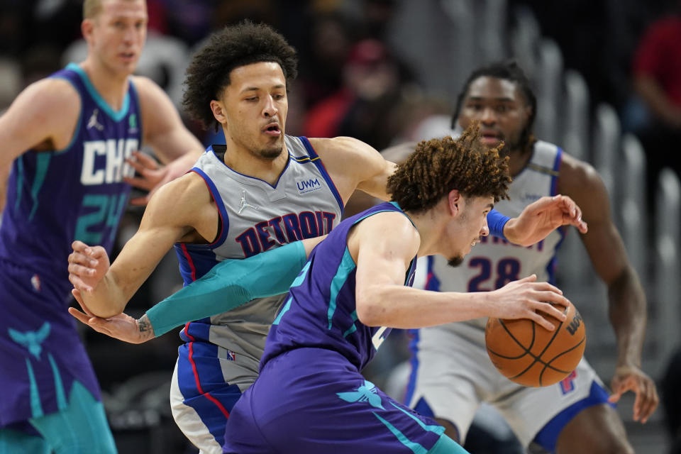 Detroit Pistons guard Cade Cunningham (2) guards Charlotte Hornets guard LaMelo Ball (2) in the second half of an NBA basketball game in Detroit, Friday, Feb. 11, 2022. (AP Photo/Paul Sancya)