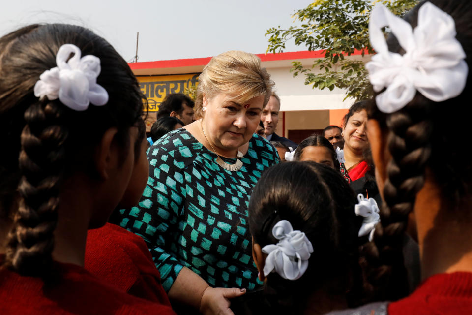 Norway’s Prime Minister Erna Solberg interacts with schoolgirls