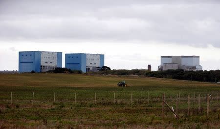 A tractor mows a field on the site where EDF Energy's Hinkley Point C nuclear power station will be constructed in Bridgwater, southwest England in this file photograph taken October 24, 2013. REUTERS/Suzanne Plunkett/Files