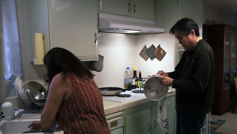 Kerry Osaki, right, helps his wife, Lena Adame, in the kitchen in Fountain Valley, Calif., Wednesday, Nov. 25, 2020. Many families spend extra time in the kitchen during the holiday season and may benefit from some high-tech kitchen devices.