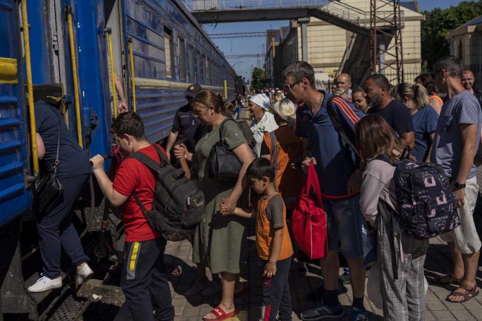 People board an evacuation train in Pokrovsk railway station, eastern Ukraine, Friday, June 10, 2022. (AP Photo/Bernat Armangue )