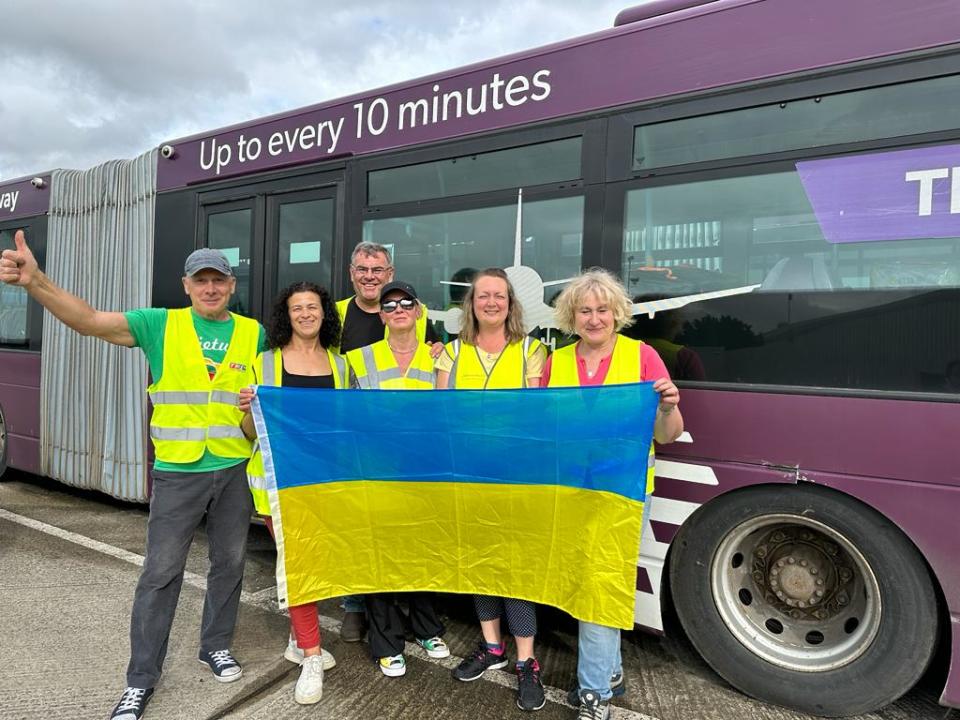 Volunteers with one of the buses donated to Ukraine.