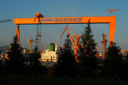 FILE PHOTO: A large crane works on the construction of a liquefied natural gas (LNG) tanker at Daewoo Shipbuilding and Maritime Engineering (DSME) yard near Geoje, South Korea October 25, 2017. REUTERS/Henning Gloystein/File Photo