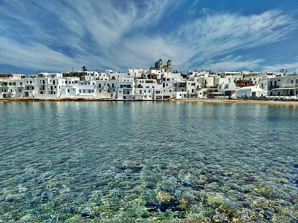 The Greek village of Naousa is postcard perfect. Think quaint white alleyways with pops of bougainvillea and seaside restaurants and bars. Photo: Getty