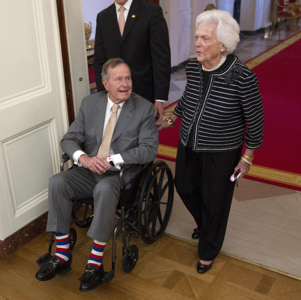 Former President George H.W. Bush, left, and his wife, former first lady Barbara Bush, arrive in the East Room of the White House in Washington, Thursday, May 31, 2012, for a ceremony to unveil the official portrait of their son former President George W. Bush. (AP Photo/Pablo Martinez Monsivais)