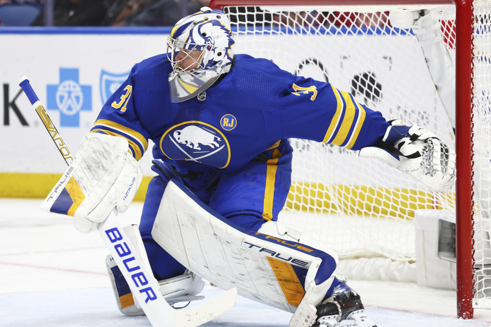 Buffalo Sabres goaltender Eric Comrie (31) slides across the crease to make a save during the second period of an NHL hockey game against the Detroit Red Wings Tuesday, Dec. 5, 2023, in Buffalo, N.Y. (AP Photo/Jeffrey T. Barnes)