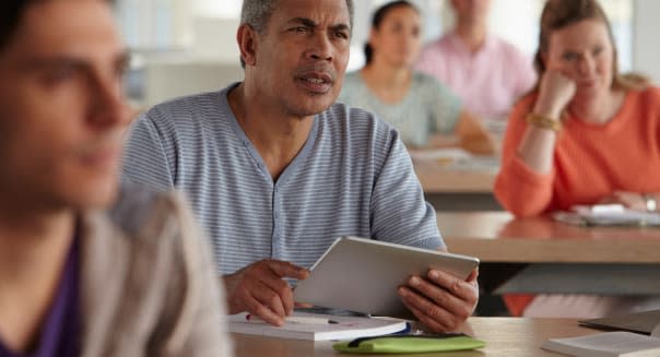 Man using digital tablet in class