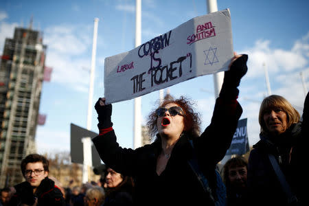 Protesters hold placards and flags during a demonstration, organised by the British Board of Jewish Deputies for those who oppose anti-Semitism, in Parliament Square in London, Britain, March 26, 2018. REUTERS/Henry Nicholls