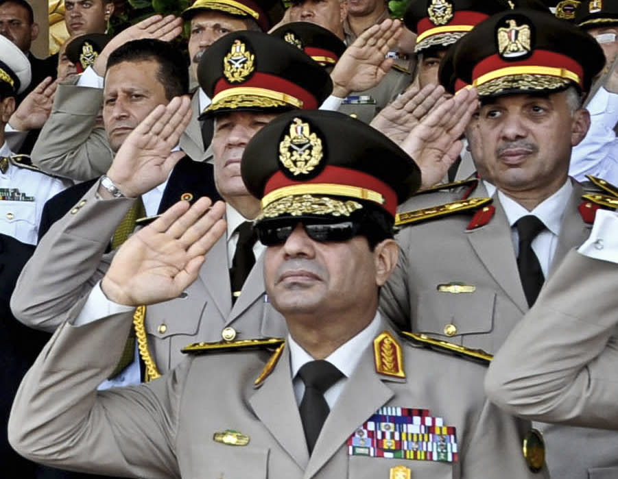 FILE - In this July 22, 2013, file photo released by the Egyptian Presidency, Defense Minister Gen. Abdel-Fattah el-Sissi, listens to the national anthem during a medal ceremony at a military base east of Cairo. The head of Egypt’s military, Abdel-Fattah el-Sissi, is riding on a wave of popular fervor that is almost certain to carry him to election as president. Unknown only two years ago, a broad sector of Egyptians now hail him as the nation’s savior after he ousted the Islamists from power, and the state-backed personality cult around him is so eclipsing, it may be difficult to find a candidate to oppose him if he runs. Still, if he becomes president, he faces the tough job of ruling a deeply divided nation that has already turned against two leaders.(AP Photo/Sheriff Abd El Minoem, Egyptian Presidency, File)