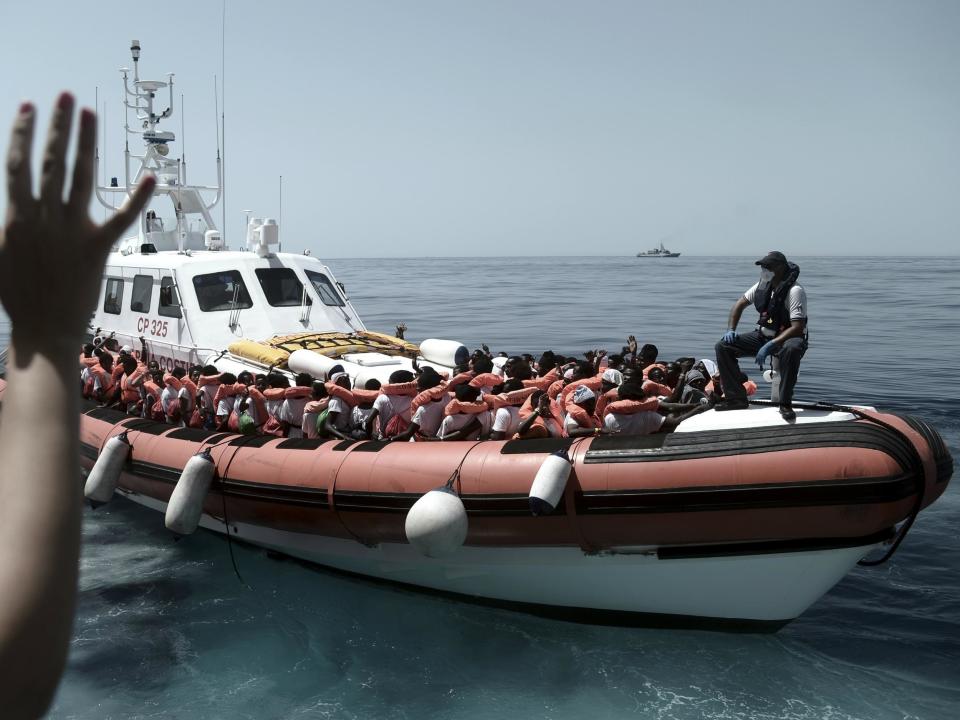 Stranded refugees on an Italian coastguard boat as they are transferred from the Aquarius to Italian ships to continue the journey to Spain: AP