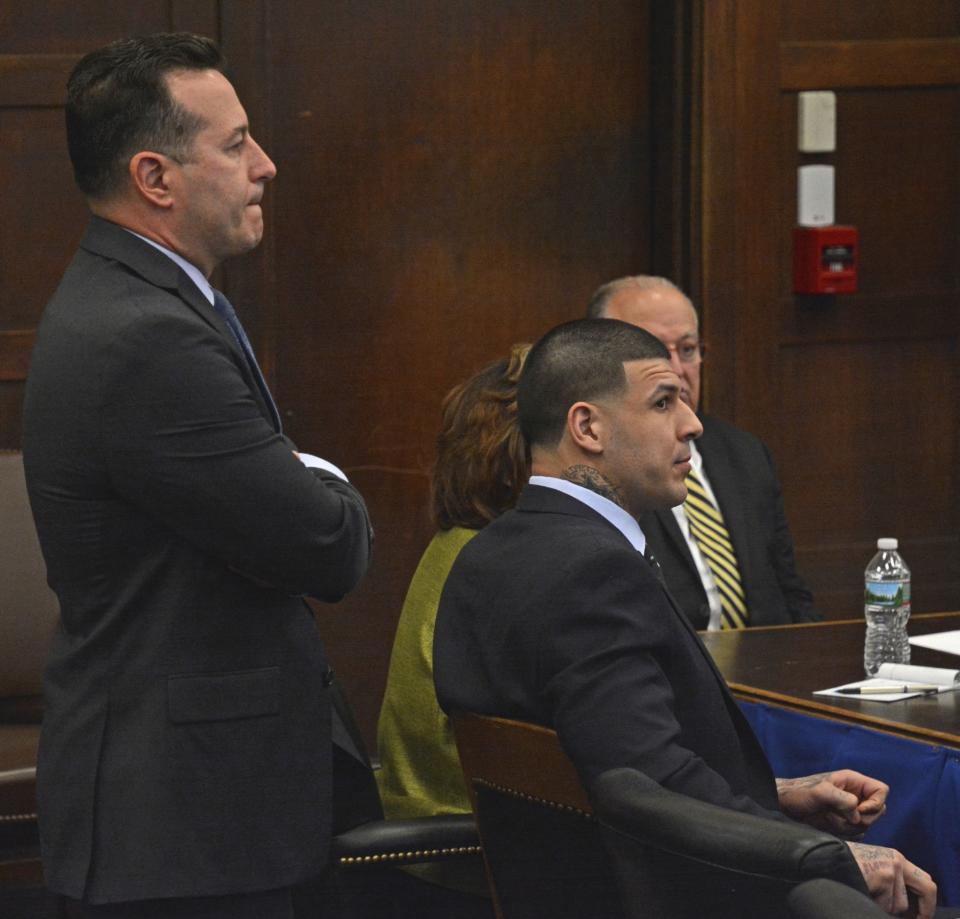 Attorney Jose Baez stands behind Aaron Hernandez as they listen to Judge Jeffrey Locke on Monday. (AP)