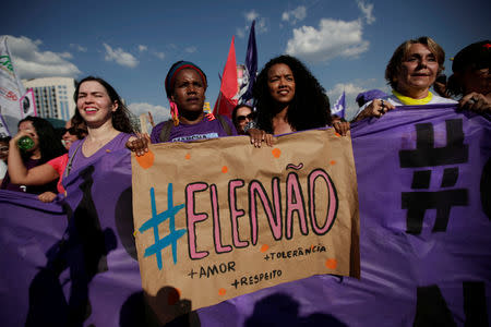 Women holds a sign that reads "Not Him" during demonstrations against presidential candidate Jair Bolsonaro in Brasilia, Brazil September 29, 2018. REUTERS/Adriano Machado