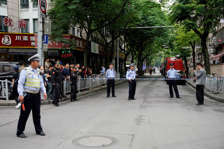 Police officers are seen near the site where a building collapsed, in Shanghai, China May 16, 2019. REUTERS/Aly Song