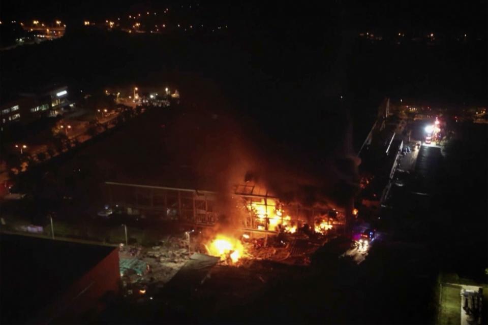 This image made from video footage run by FTV shows an aerial view of a factory of golf ball manufacturer Launch Technologies Co. caught on fire in the southern county of Pingtung in Taiwan on Friday, Sept. 22, 2023. The golf ball factory fire has left multiple people killed, and the victims include several firefighters, according to Taiwanese media reports. (FTV via AP)