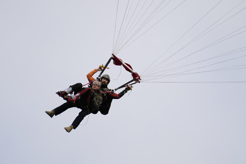 Texas Gov. Greg Abbott skydives in tandem Monday, Nov. 27, 2023, in Fentress, Texas. Abbott was invited to jump by 106-year-old World War II veteran Al Blaschke. (AP Photo/Eric Gay)