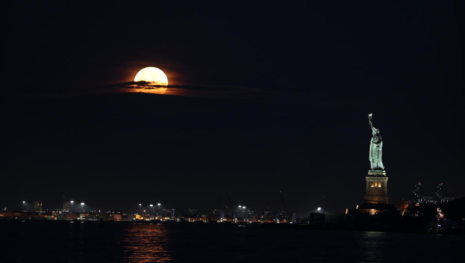 NEW YORK, UNITED STATES - JULY 3: Supermoon also known as 'Buck Moon' sets over the Statue of Liberty in New York City, United States on July 3, 2023. (Photo by Lokman Vural Elibol/Anadolu Agency via Getty Images)