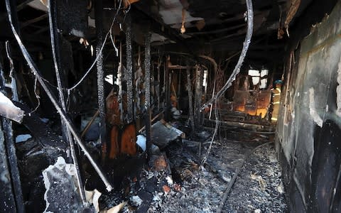 Charred debris left after the blaze at a hospital in South Korea - Credit: AFP