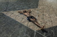 Kais Bothe relaxes in the cool in the city hall pool, as temperatures hit 37 degrees Celsius in Edmonton, Alberta, on Wednesday, June 30, 2021. (Jason Franson/The Canadian Press via AP)