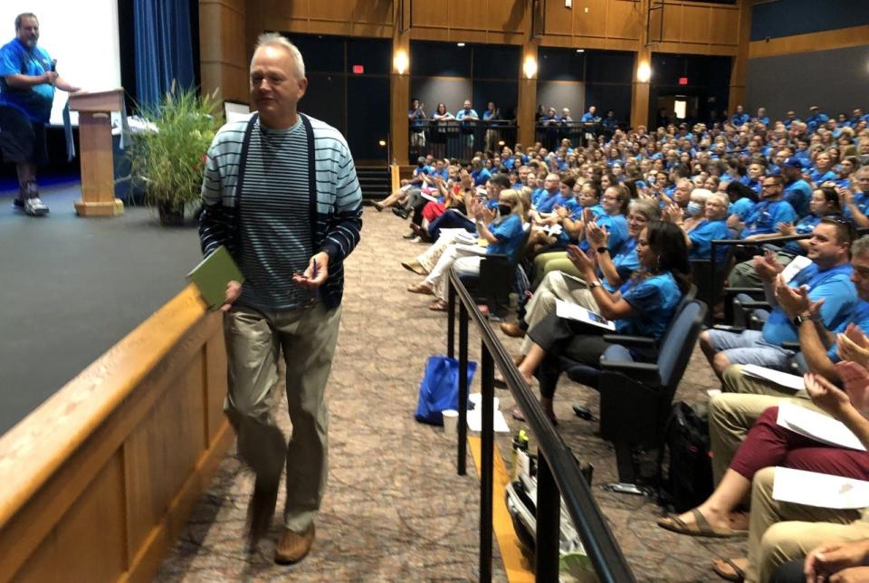 Author and literacy specialist Lester Laminack approaches the stage as the first guest presenter at RSU 21's back-to-school symposium on Thursday, Aug. 25, 2022.