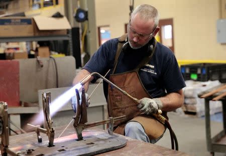 Sub-assembly worker Nate Poort works on braizing loops together for transformers at RoMan Manufacturing in Grand Rapids, Michigan, U.S. December 12, 2018. Picture taken December 12, 2018. REUTERS/Rebecca Cook