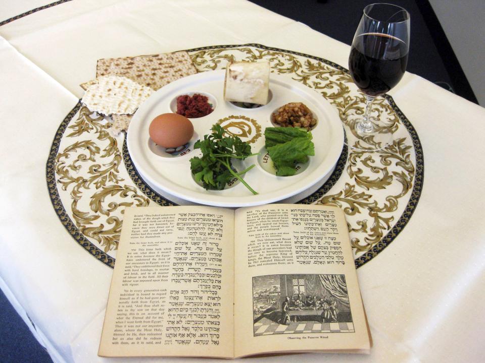 A 1936 Maxwell House Haggadah sits on a desk alongside a Seder plate in this March 2011 photo. Each item on the Seder plate has a significance in the story of Moses and Passover as told in the Book of Exodus.