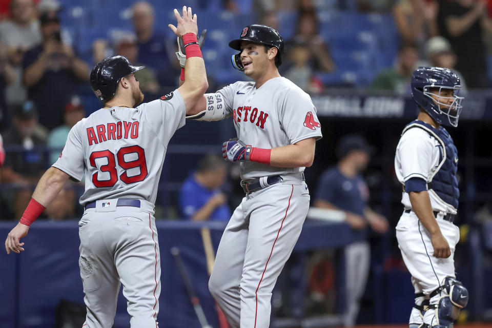 Boston Red Sox's Triston Casas, center, is congratulated by Christian Arroyo on his two-run home run, next to Tampa Bay Rays catcher Francisco Mejia during the second inning of a baseball game Tuesday, Sept. 6, 2022, in St. Petersburg, Fla. (AP Photo/Mike Carlson)