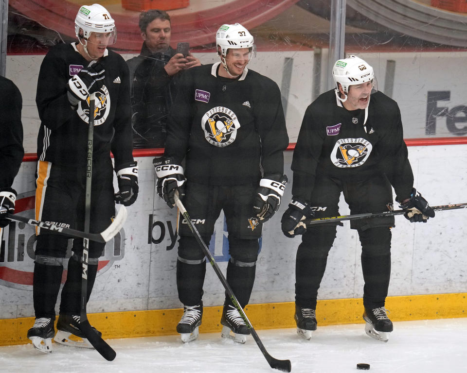 Pittsburgh Penguins' Evgeni Malkin (71), Sidney Crosby (87) share a laugh with former Penguins player Jaromir Jagr during NHL hockey practice, Feb. 17, 2024 in Cranberry, Pa. Jagr, who spent 11 seasons playing for the Penguins, will have his No. 68 officially retired during a pre-game ceremony before an NHL hockey game between the Los Angeles Kings and Penguins on, Sunday. (AP Photo/Gene J. Puskar)
