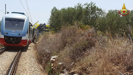 Two passenger trains are seen after a collision in the middle of an olive grove in the southern village of Corato, near Bari, Italy, in this handout picture released by Italian Firefighters July 12, 2016. Italian Firefighters/Handout via Reuters